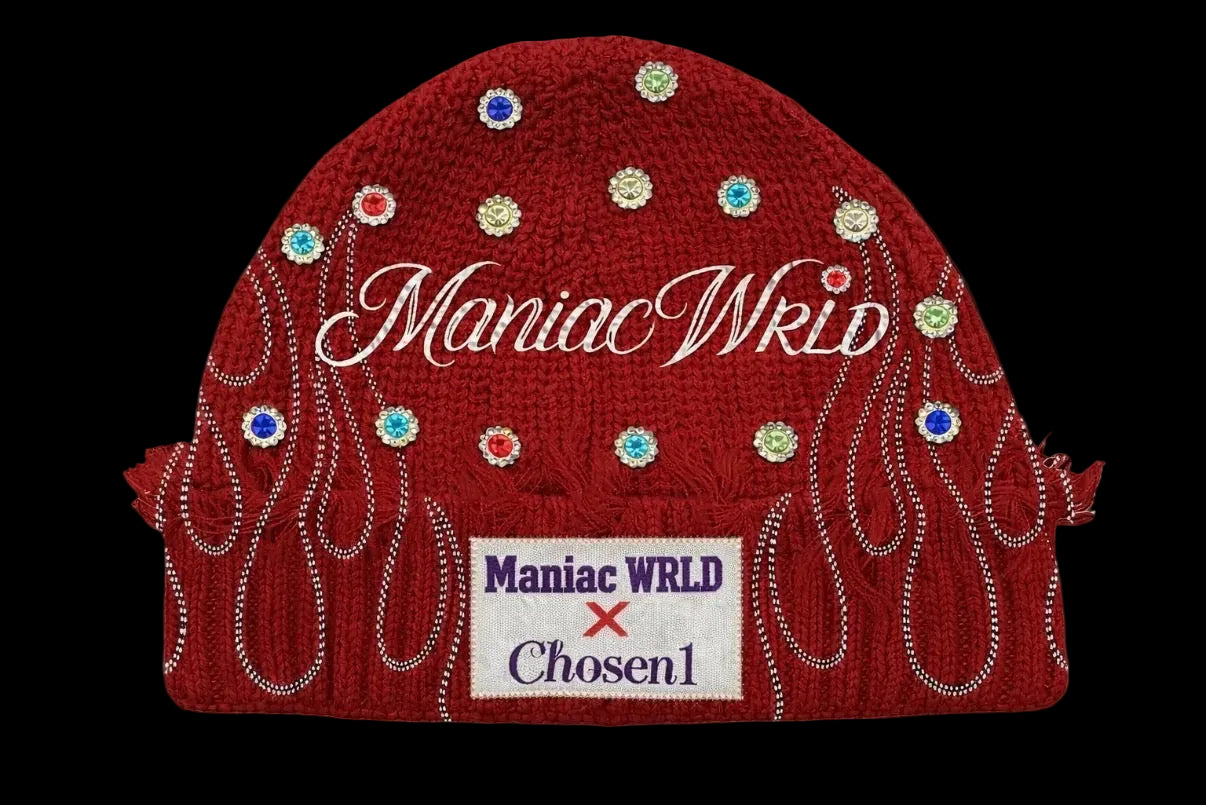 Red beanie with 'Maniac WRLD' branding and colorful embellishments on a black background